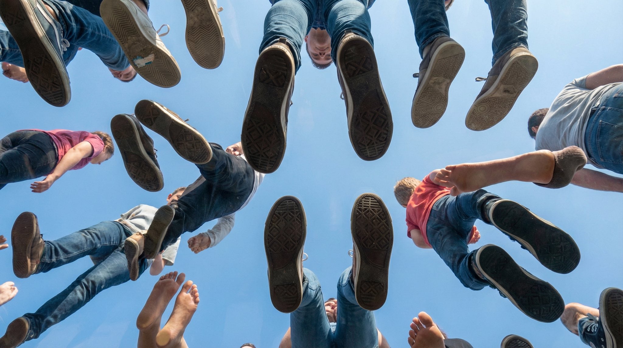 People Walking on Transparent Plexiglass Above — image 3