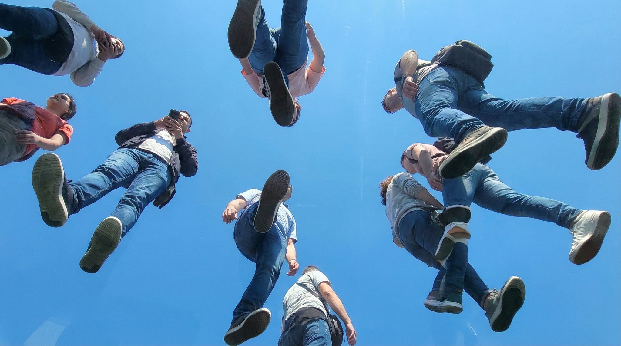 People Walking on Transparent Plexiglass Above — image 4