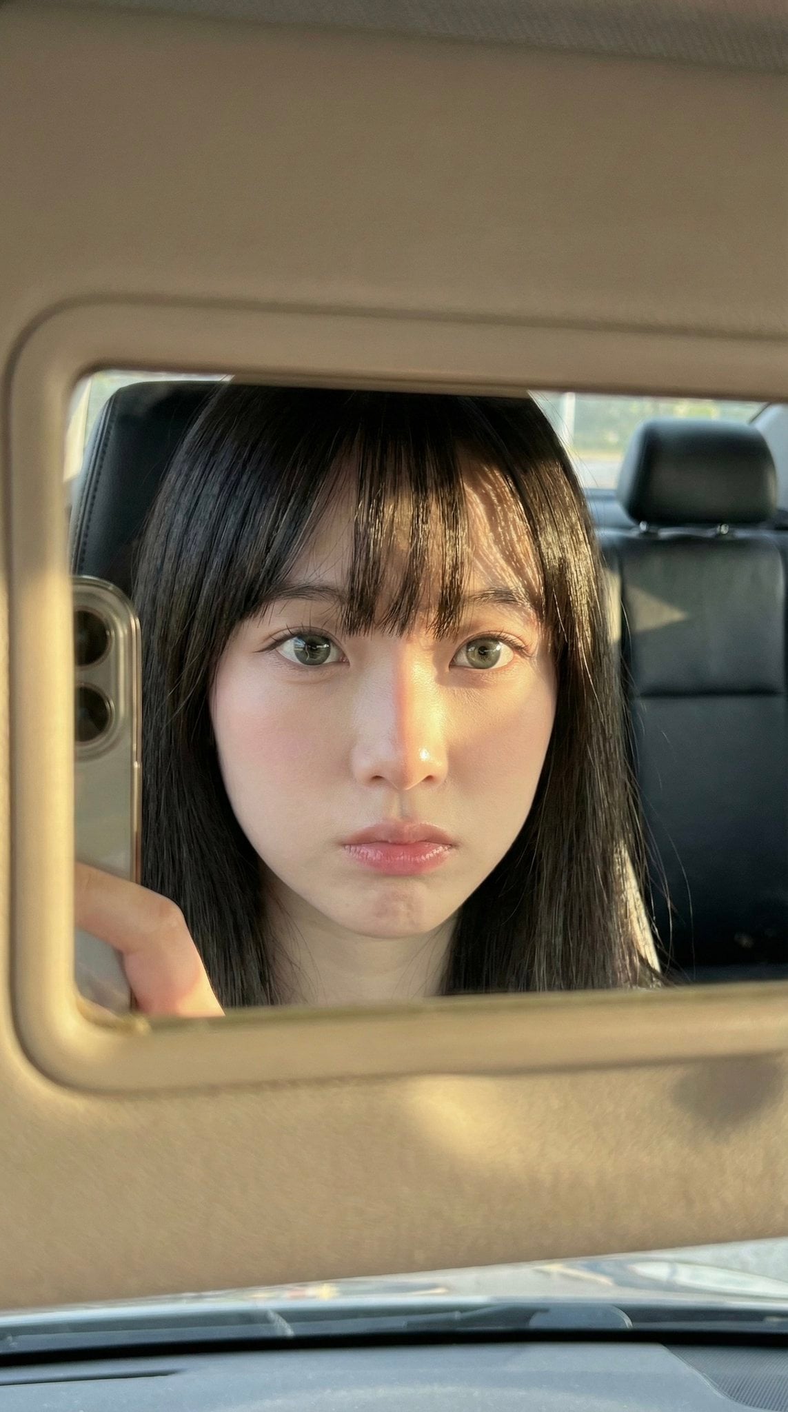 Woman's Face Reflection in Car Mirror