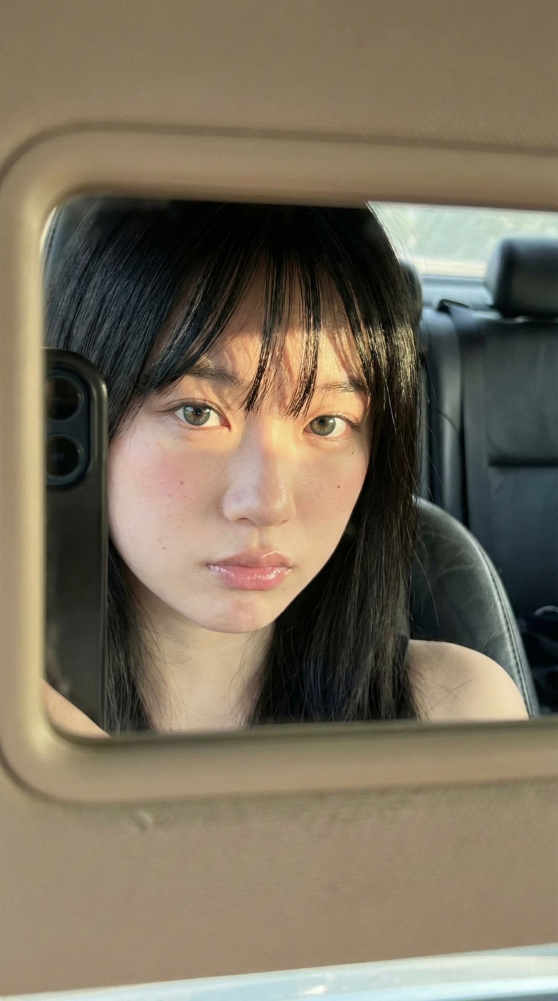 Woman's Face Reflection in Car Mirror — image 2