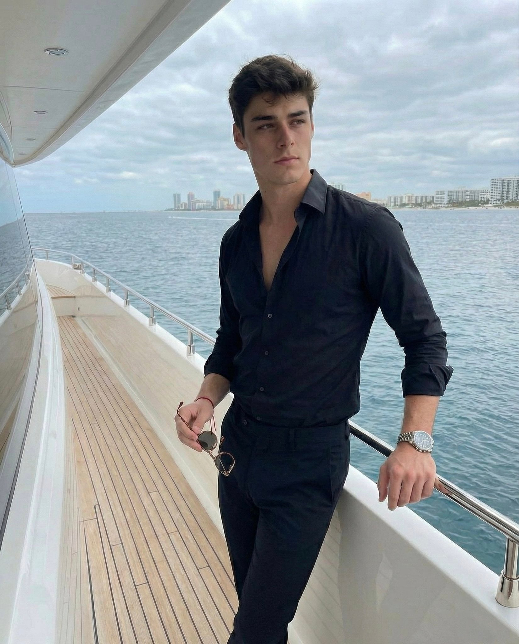 Young Man Contemplating Seascape and Cityscape — image 2