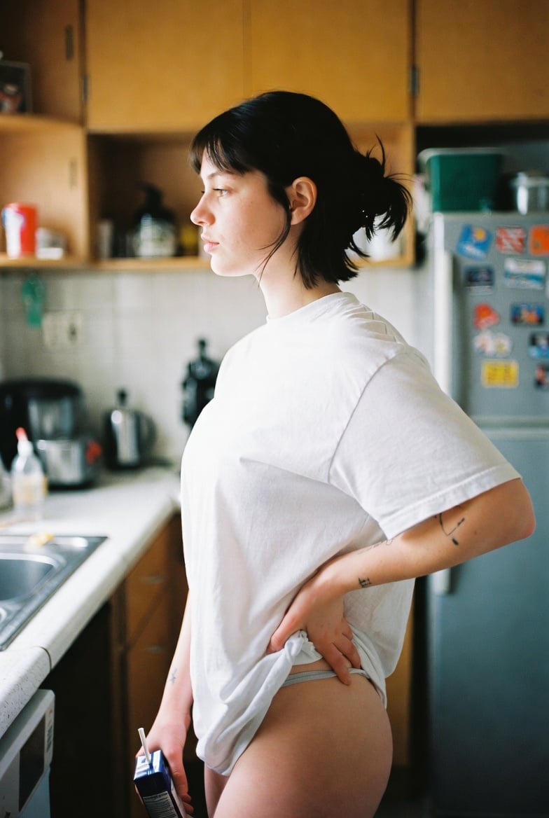 Woman Holding Drink in Kitchen