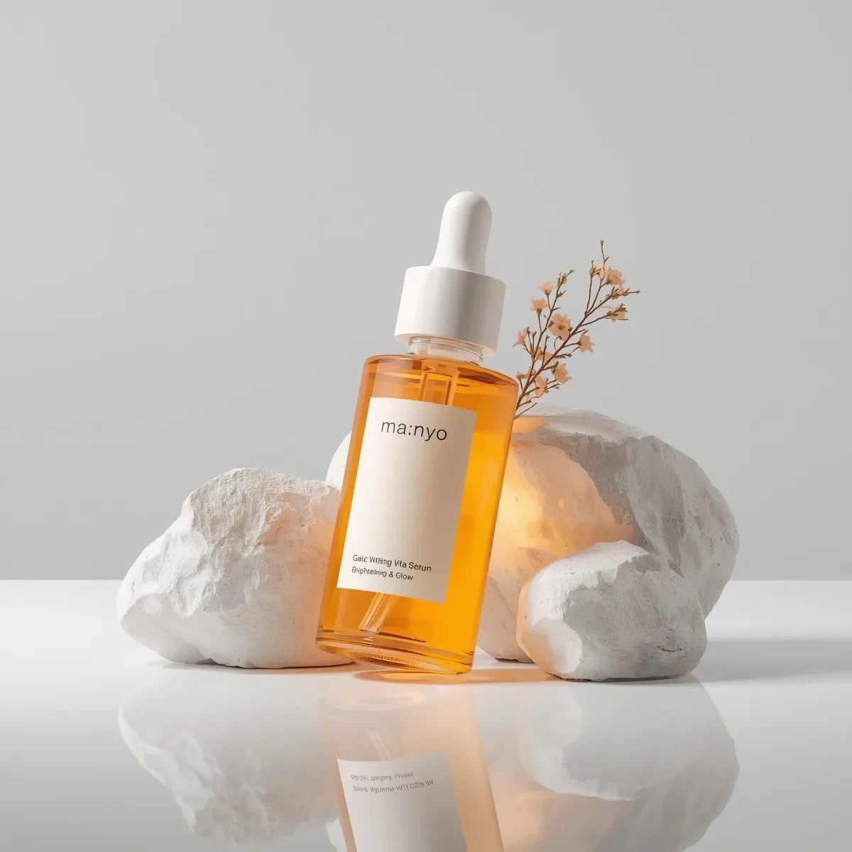 Amber Serum Bottle Surrounded by Stone and Flowers — image 3